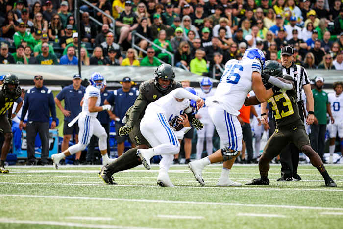 Oregon Ducks outside linebacker DJ Johnson tackles BYU quarterback Jaren Hall in week 3 at Autzen Stadium.
